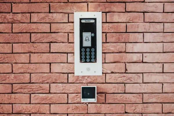 Intercom system with keypad and bell button for secure building access.