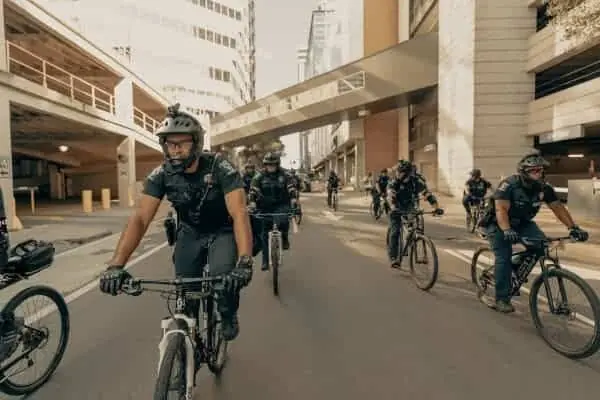 Police officers cycling during urban training session.